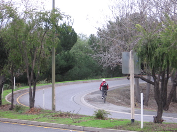 Bicyclist using sidewalk of on-ramp. (NE side)