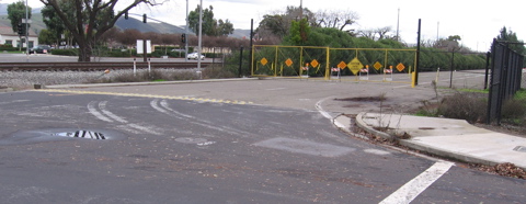 End of sidewalk from Cottle Road (seen right) is at the unofficial RR crossing, with no other continuation but the sidewalk on Monterey, across the tracks.