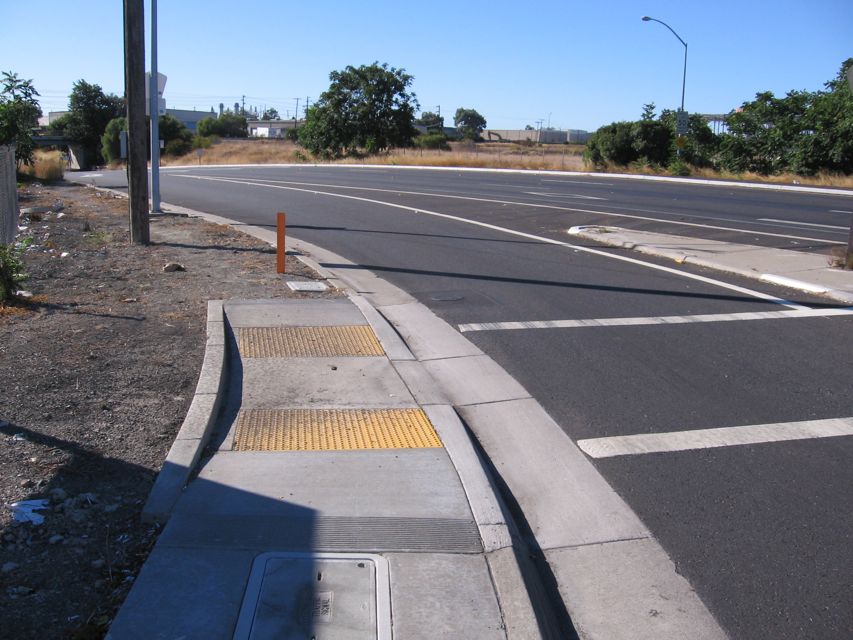 Central at DeLaCruz (SW corner). Path continues, but is bad shape.