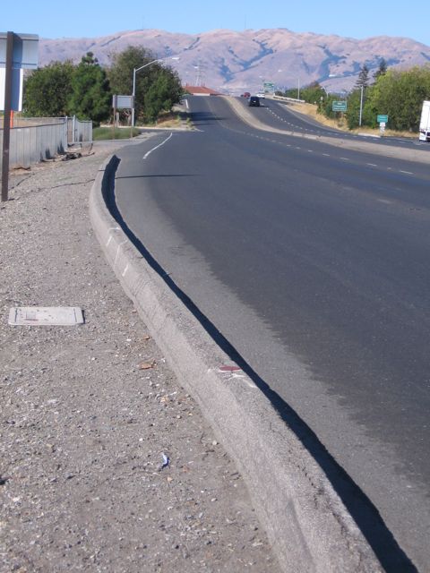 People walk on gravel: DeLaCruz, from Central to 101 bridge. Bridge has Caltrans' sidewalk.